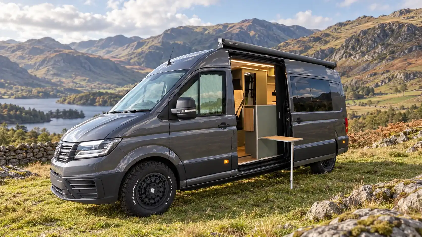 Luxus campervan on a VW Crafter LWB parked in the hills, with the sliding door open and the table out