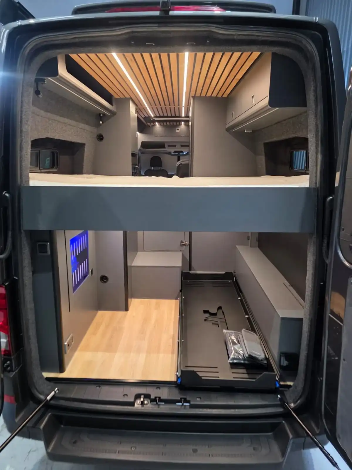 Bed and garage from the back doors of a Luxus Pop-top MAN TGE campervan