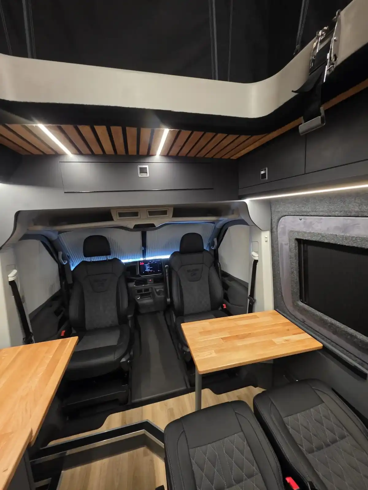 Looking forward to the swivel cab seats and tables in a Luxus Pop-top campervan