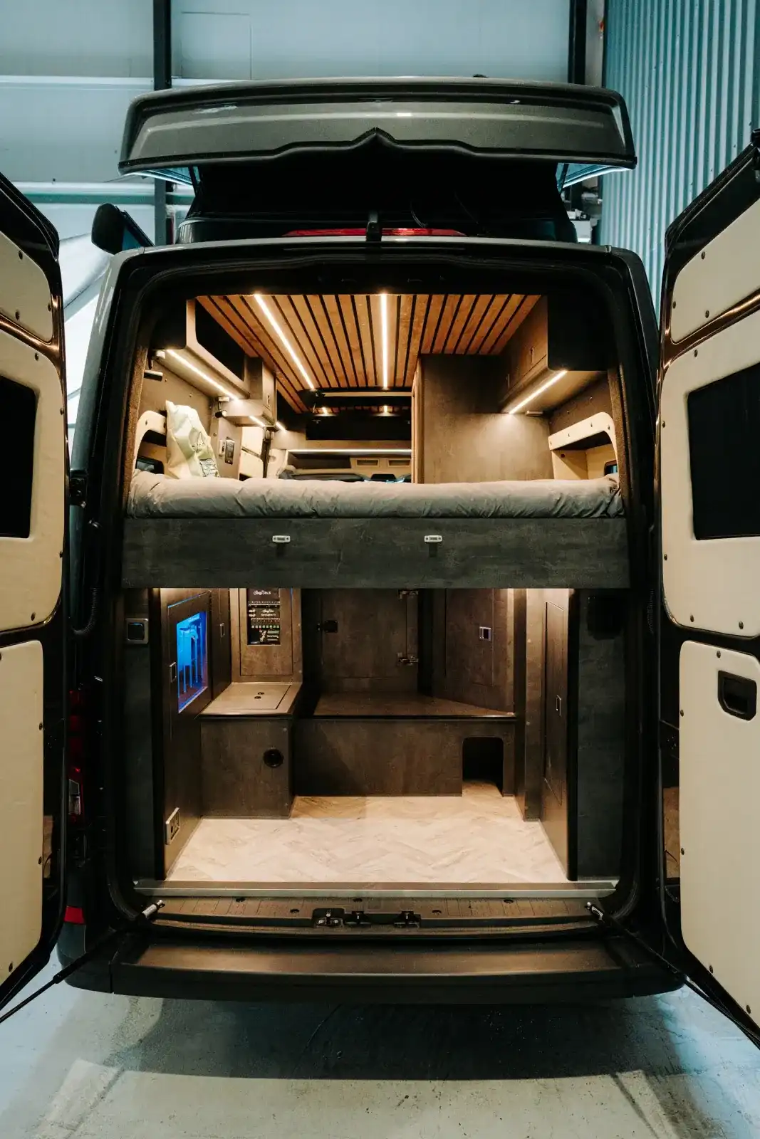 Bed and pop-top from the back doors of a Ventus Pop-top MAN TGE campervan
