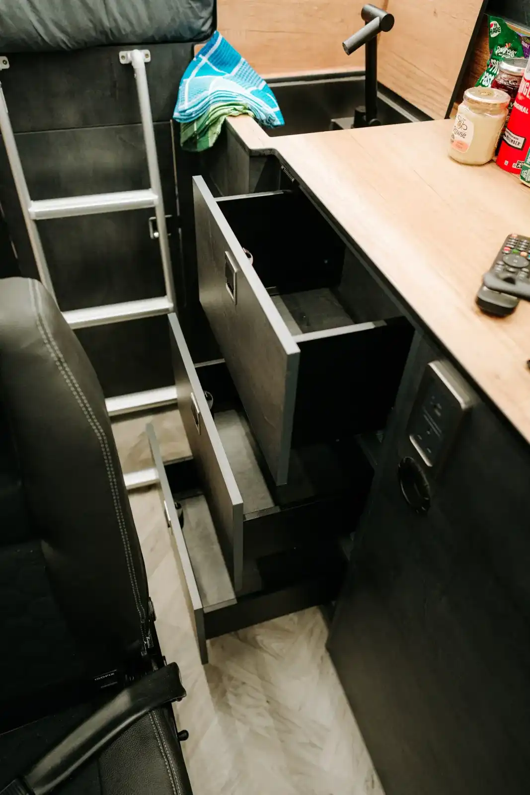 Kitchen drawers open under the worktop of a Ventus Pop-top campervan