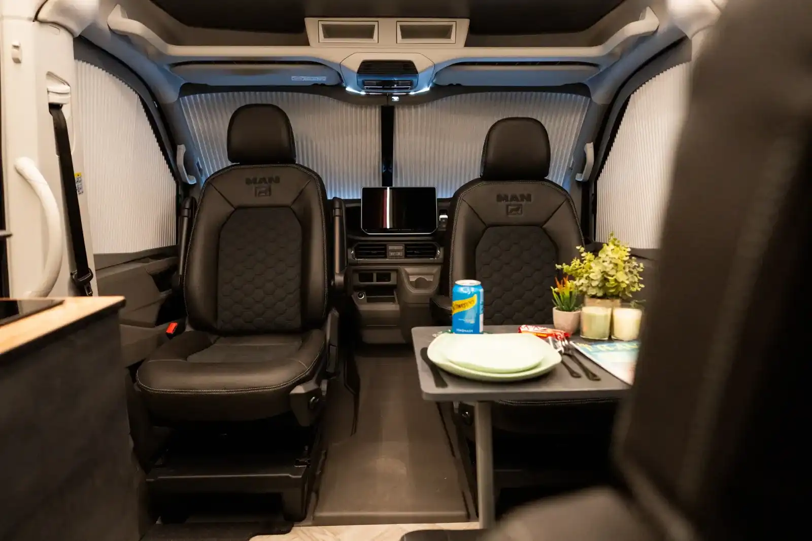 Swivelled cab seats and dining table inside one of our conversions